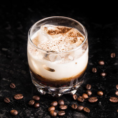 White russian with coffee beans on a table