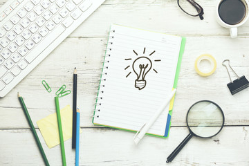 lighting bulb on notebook with keyboard