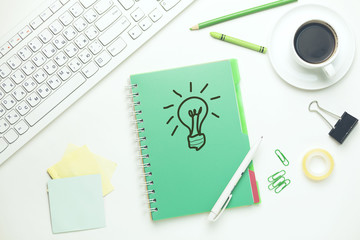 lighting bulb on notebook with keyboard