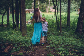 mother and son are in the summer woods