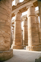 big stone columns with carving figures and hieroglyphs in landmark Egyptian Karnak Temple, public ancient monument declared a World Heritage by Unesco, in Luxor, Egypt, Africa
