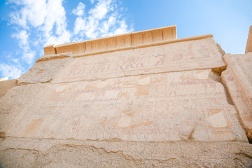 big stone wall with carving figures and hieroglyphs in landmark Egyptian Karnak Temple, public monument declared a World Heritage by Unesco, in Luxor, Egypt, Africa
