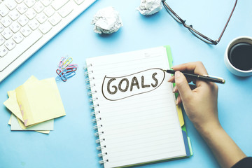 woman written goals text on notepad