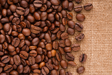 coffee beans on burlap background. roasted coffee beans isolated in white background. Roasted coffee beans background close up. Coffee beans pile from top on white background with copy space for text