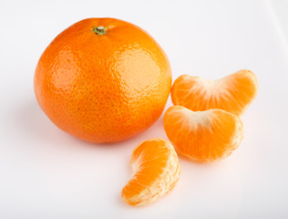 Ripe mandarin close-up on a white background. Tangerine orange. Colorful Food and drink still life concept. Fresh fruits and vegetables on color background. Clementine. Citrus. Fresh fruits. Diet.