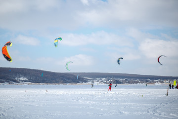snow kiting on a snowboard on a frozen lake