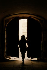 silhouette of young  woman hipster walking in the street of an o