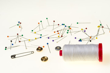 Background with Colored Pins, thread spool safety pin and metal