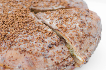 Chocolate cake with chocolate cream on plate, on light background.