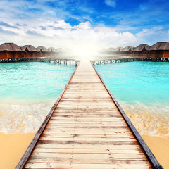 Fototapeta na wymiar Water bungalows resort at islands. Indian Ocean, Maldives