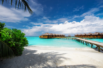 Fototapeta na wymiar Water bungalows resort at islands. Indian Ocean, Maldives