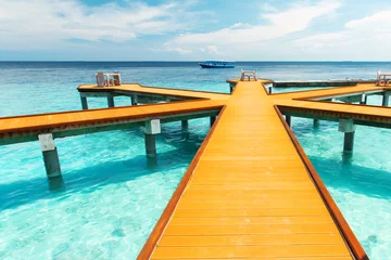 Fotobehang Wooden pier at tropical island resort, Maldives © Ivan Kurmyshov