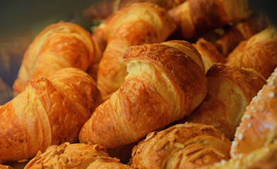Freshly baked golden croissants close up