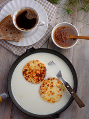 Cheese in milk, cloudberry jam, and coffee