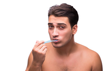 Handsome man brushing his teeth isolated on white