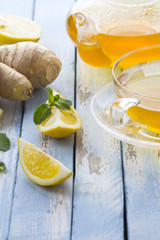 tea ginger lemon mint vintage wood background
