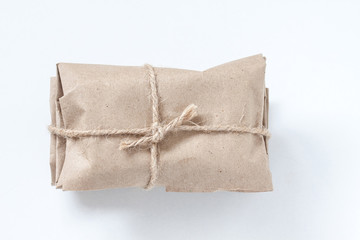 Wrapped parcel, paper package tied with burlap rope. Packaging and delivery service wallpaper
