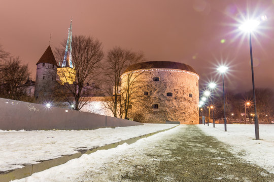 Medieval fortification tower with church on background