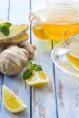 tea ginger lemon mint vintage wood background
