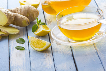 tea ginger lemon mint vintage wood background

