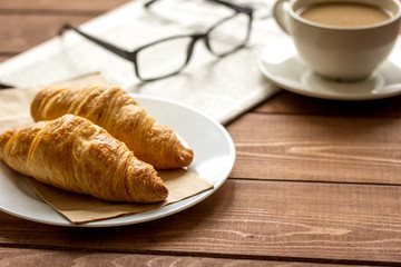 Businessman morning cup of coffee at home with newspaper