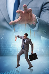 Businessman puppet being manipulated by boss