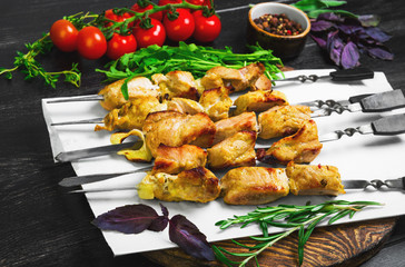 Pork meat shish kebab with onions on iron skewers grilled over f