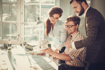 Confident team of engineers working together in a architect studio.