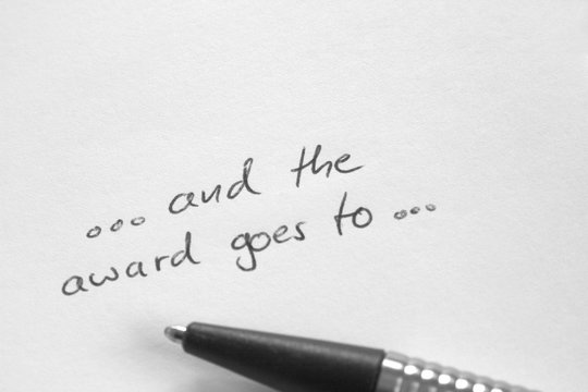 Handwritten ...and the award goes to, on white paper