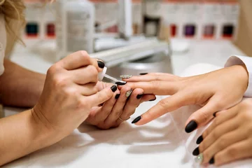 Papier Peint photo Lavable ManIcure Manicure process in beauty salon, close up. Black nails.