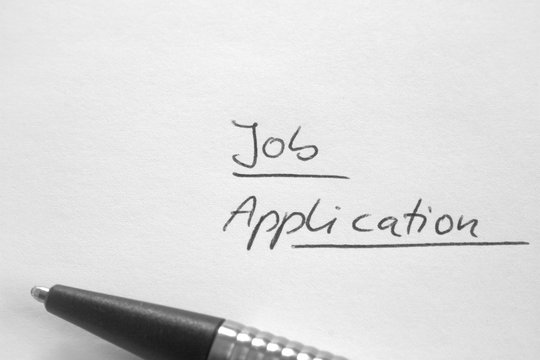 Handwritten phrase 'Job Application' on white paper