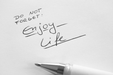 Fototapeta premium Enjoy Life, do not forget, handwritten phrase on white paper