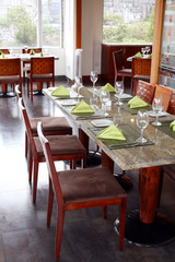 Fototapeta na wymiar interior of restaurant: professional table setting in luxury european cafe 