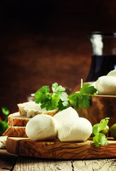 Mozzarella cheese, bread, olives and tomatoes, snack plate. Vint