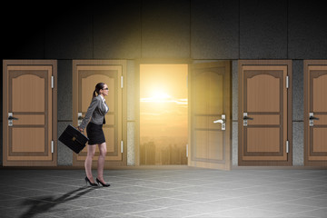 Businesswoman walking towards open door