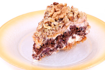 portion of white and brown chocolate walnut cake with walnuts
