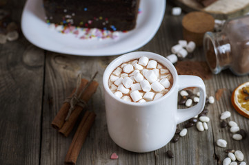 cup of chocolate drink with marshmallows into small pieces