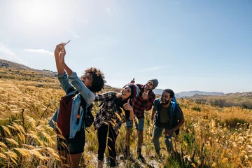 Tuinposter Friends taking selfie on countryside hike © Jacob Lund