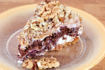 portion of white and brown chocolate walnut cake with walnuts
