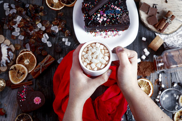 female hands holding a cup with a drink