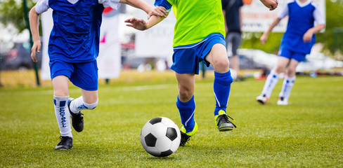 Soccer Training Match For Children Youth Teams. Young Boys Running and Kicking Football Ball on the Pitch