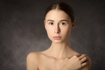 Woman with a natural beauty makeup look on black background