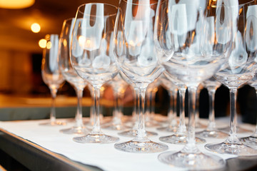 a lot of glasses of champagne on a table in a restaurant
