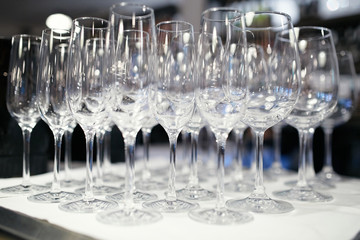 a lot of glasses of champagne on a table in a restaurant