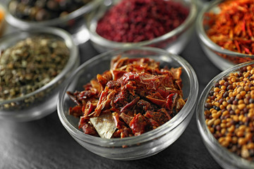 Various spices in glass bowls, closeup