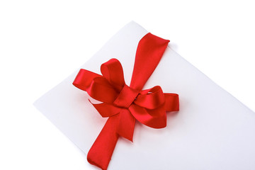Close up of card note with red ribbon on white background