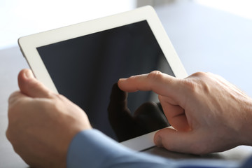 Senior man using tablet on table