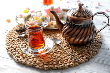 Turkish tea in traditional glass on wicker mat closeup