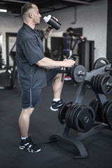 Fototapeta na wymiar Muscular man has pause in gym
