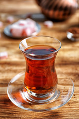 Turkish tea in traditional glass on wooden table closeup
